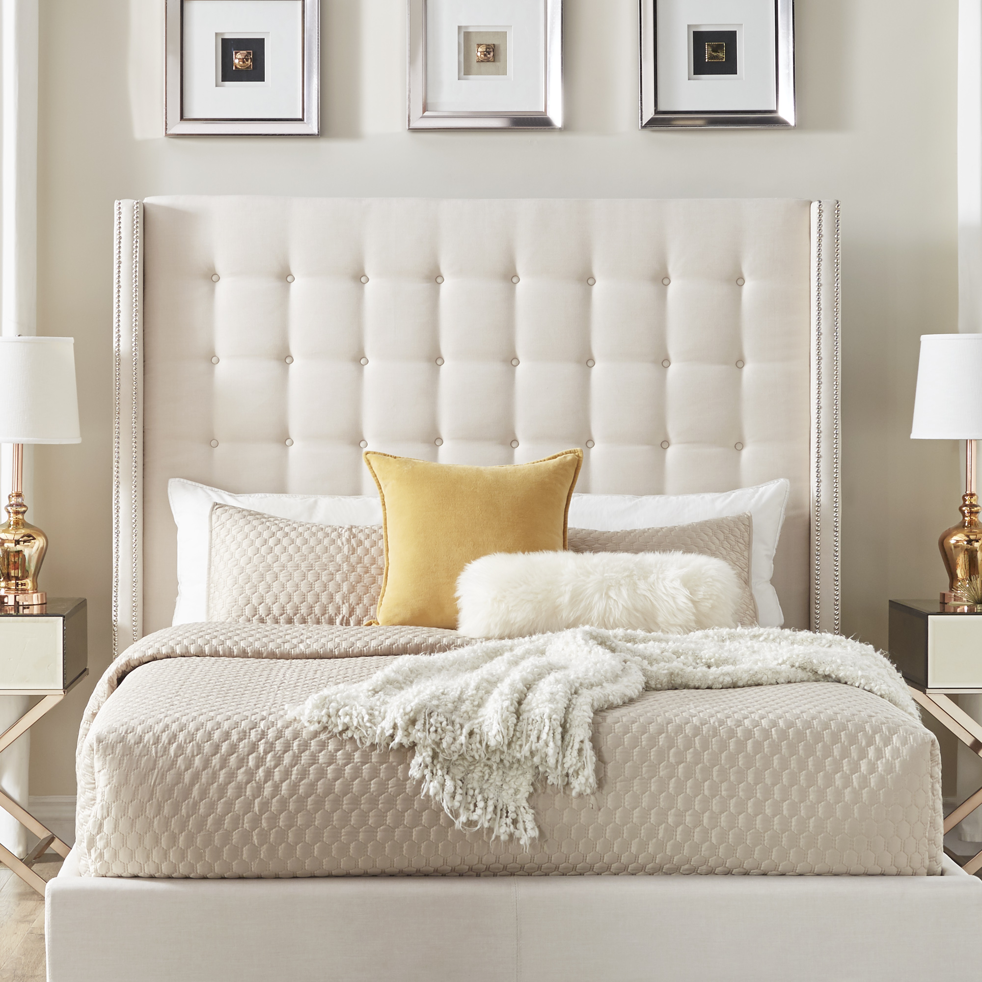 This blog is going to show you how to make your guests feel right at home. Pictured here is the Button Tufted Nailhead Trim Wingback Bed in beige linen upholstery from iNSPIRE Q. This bed is paired with white, yellow, and beige bedding, exuding plush comfort.