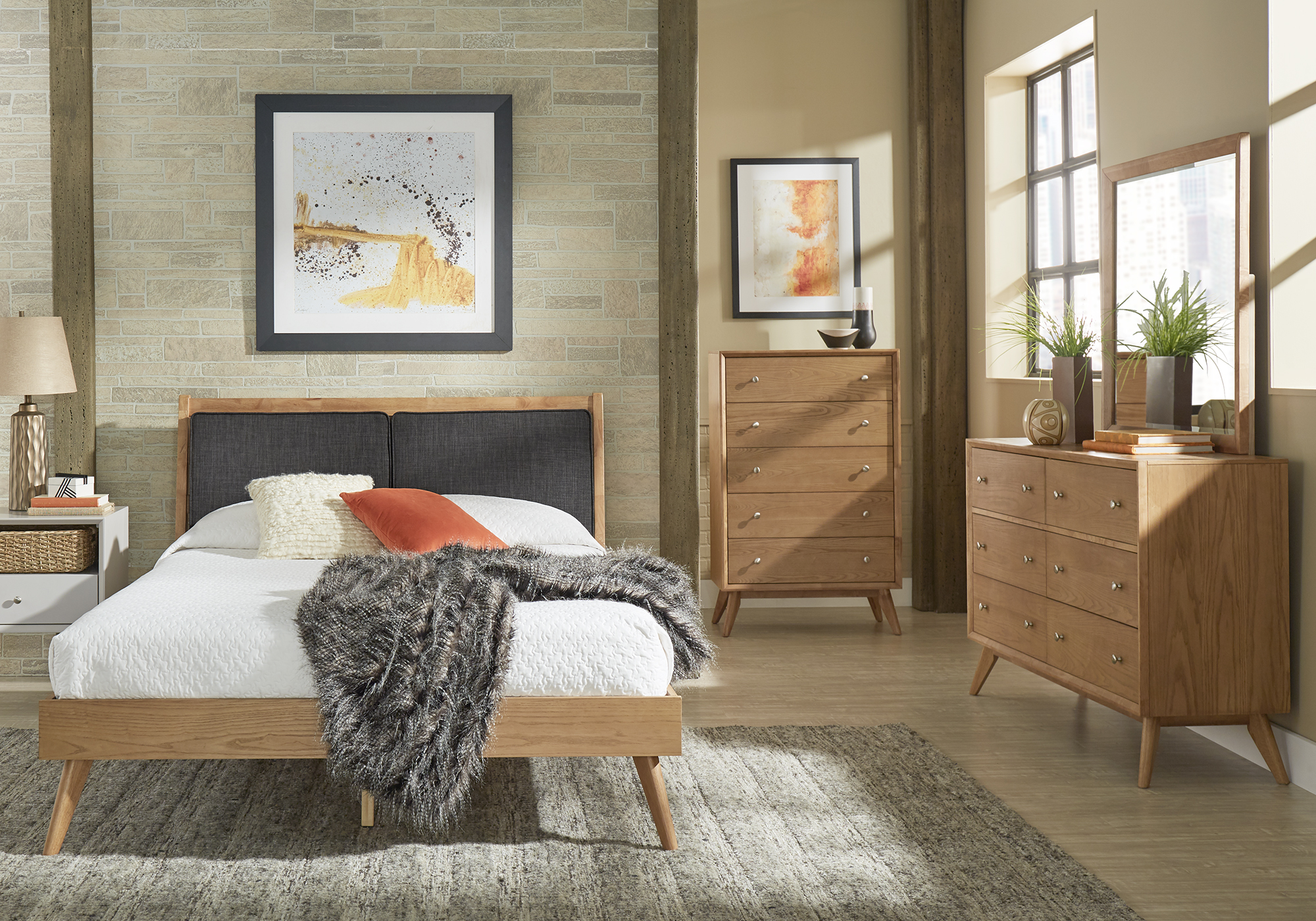 Natural wood is another technique we suggest in our guide on how to make your guests feel right at home. This mid-century modern bedroom pictured here has a natural wood finish platform bed, a natural wood finish dresser, and a matching natural wood finish chest.
