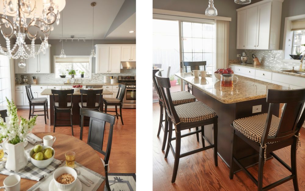 There are two images showcasing the kitchen of the Illinois home makeover. The left image is a more faraway view of the kitchen island with the four panel back antique black stools. It also features part of the round dining table and matching antique black panel back dining chairs. The right image is a closer view of the kitchen island from a different angel. The kitchen island is surrounded by four wood panel back antique black stools. Each stool has a black and white checkerboard seat cushion.