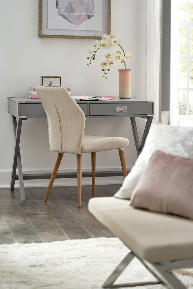 Off to the side in our bedroom, this image shows our grey campaign writing desk and a contoured, linen upholstered chair. We also have a glimpse of our beige linen upholstered bench in the foreground.