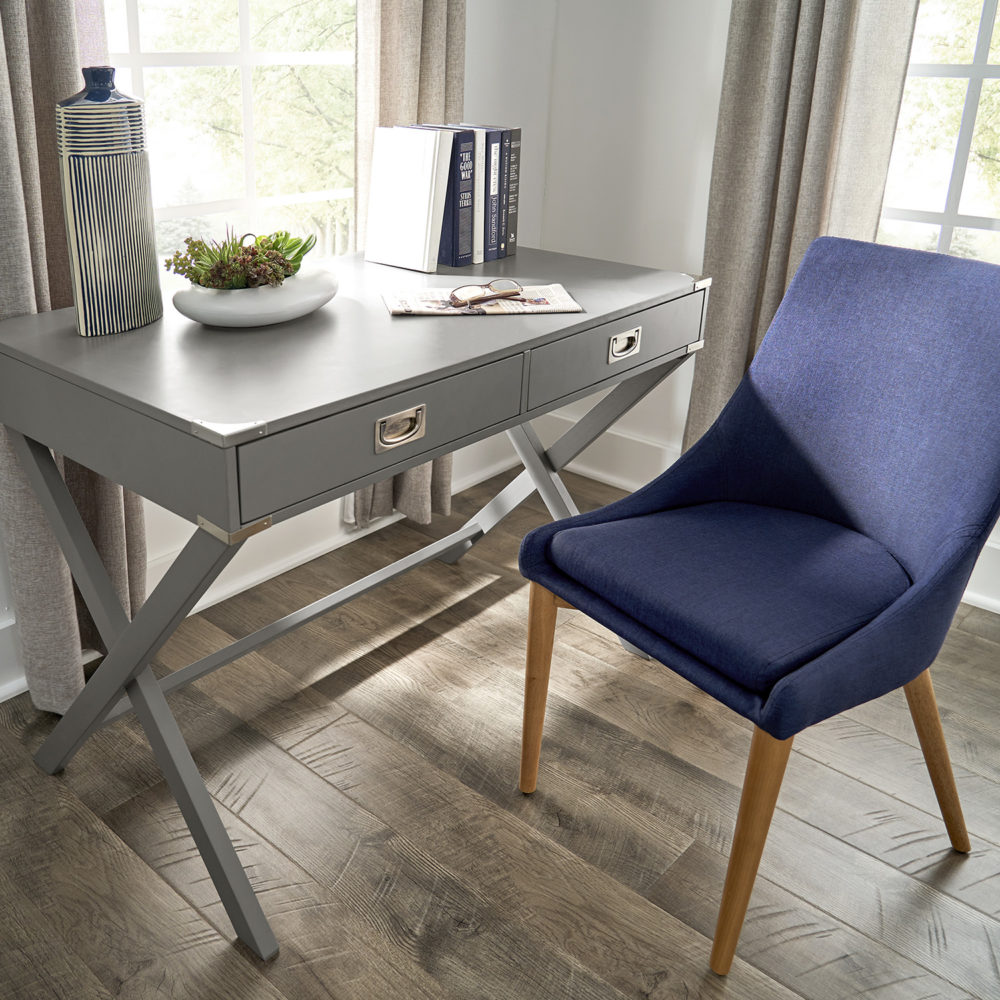 This image focuses on the grey finish campaign writing desk and twilight blue linen upholstered barrel back side chair. These colors complement the bedding (not pictured) and unite the masculine theme for our canopy bed ideas.