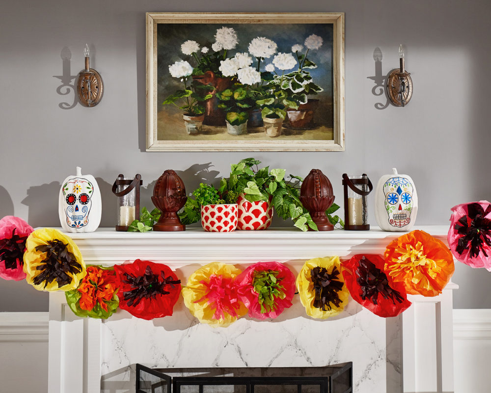 Pictured here is the Day of the Dead-inspired marigold and poppy paper garland hanging across the fireplace mantle.