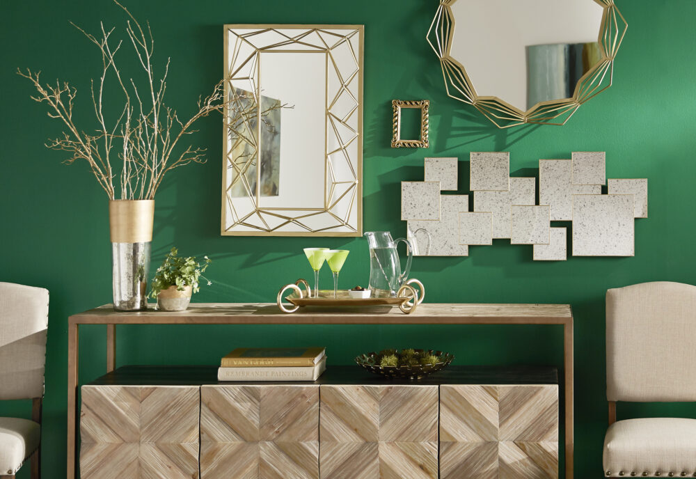 This picture shows what this post is all about: mirror decorating ideas. Three different mirrors hang over a server for an eye-catching look.
