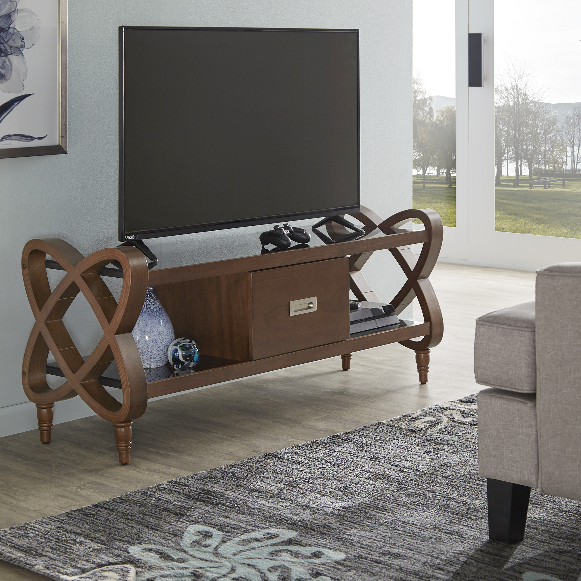 This is our Walnut Finish TV Stand With Black Tempered Glass Top & Bottom. It features a flat screen on top of it.