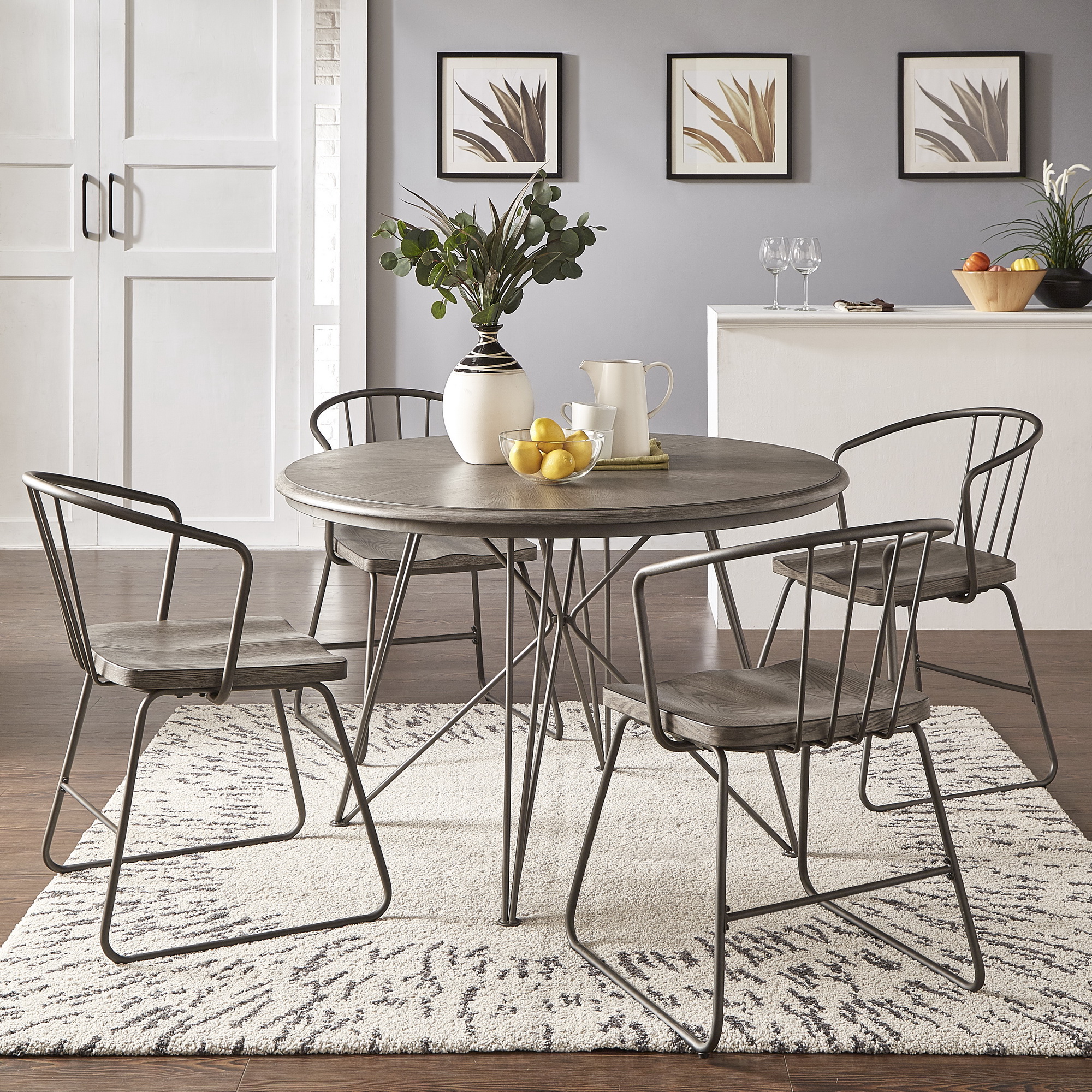 The other metal most commonly found among furniture materials is iron. Here we have pictured the Iron and Grey Wood Round 5-Piece Dining Set by iNSPIRE Q Modern. This set includes a round dining table with a grey wood table top and iron pedestal base. The four matching chairs have grey wood seats and iron frames.