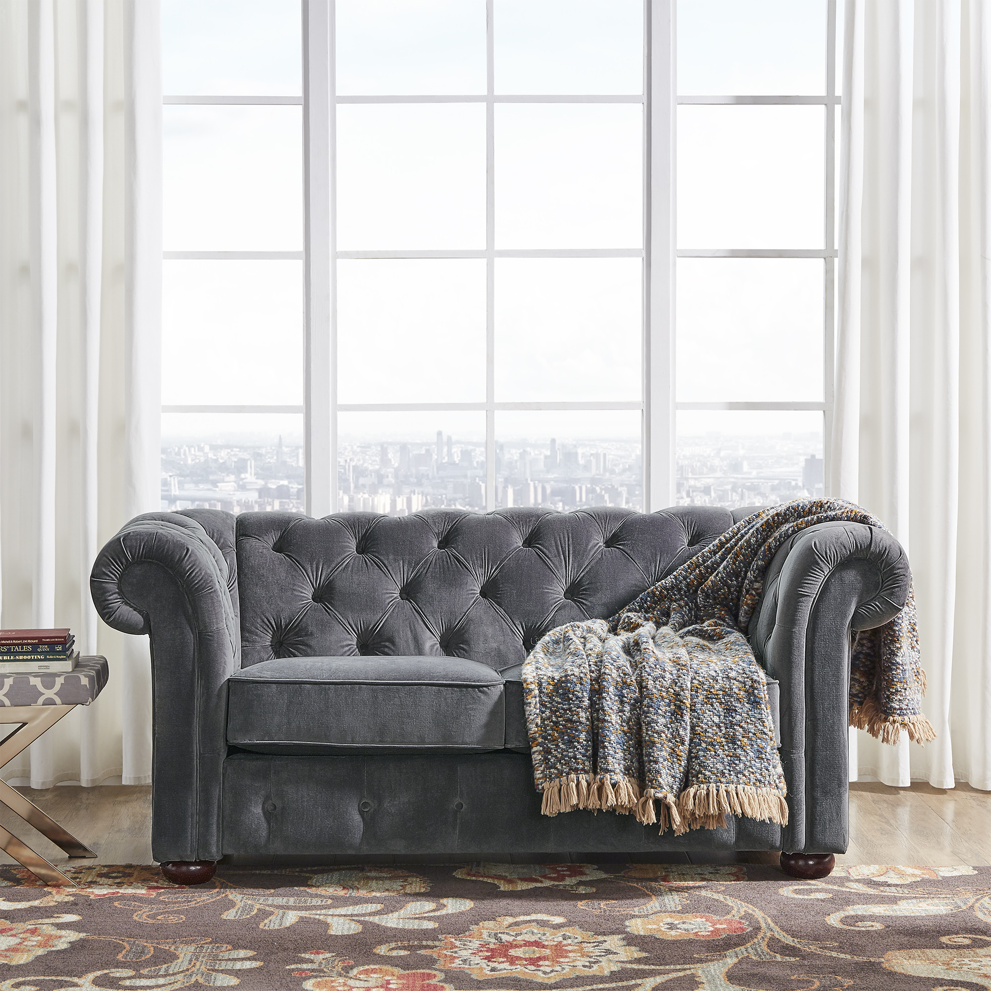 In this guide on how to buy furniture online, we wanted to show the different types of seating you could have in a living space. This image depicts the Dark Grey Velvet Chesterfield Loveseat from iNSPIRE Q Artisan.