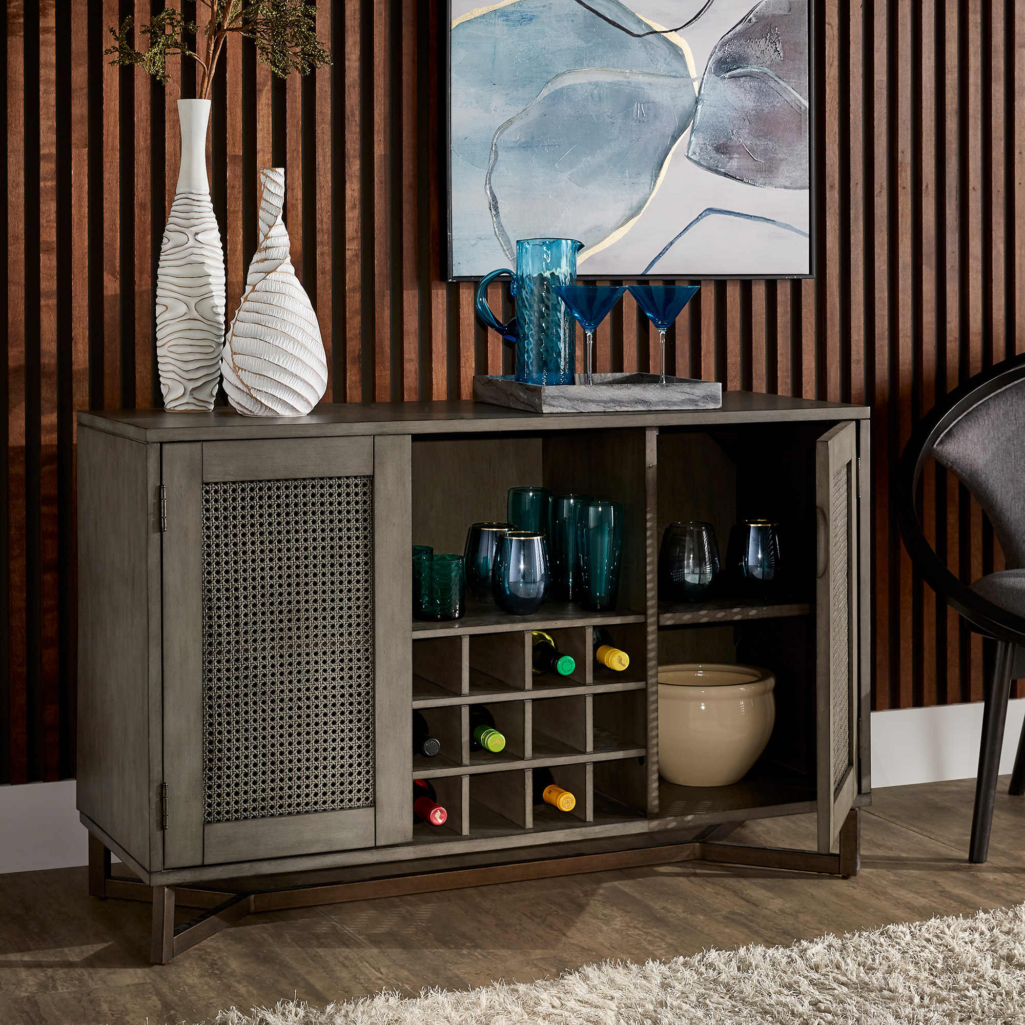 This is the Grey Wood Rattan Wine Rack Buffet Server by iNSPIRE Q Modern. It's multitude of storage capacity allows it to be used anywhere in the home.