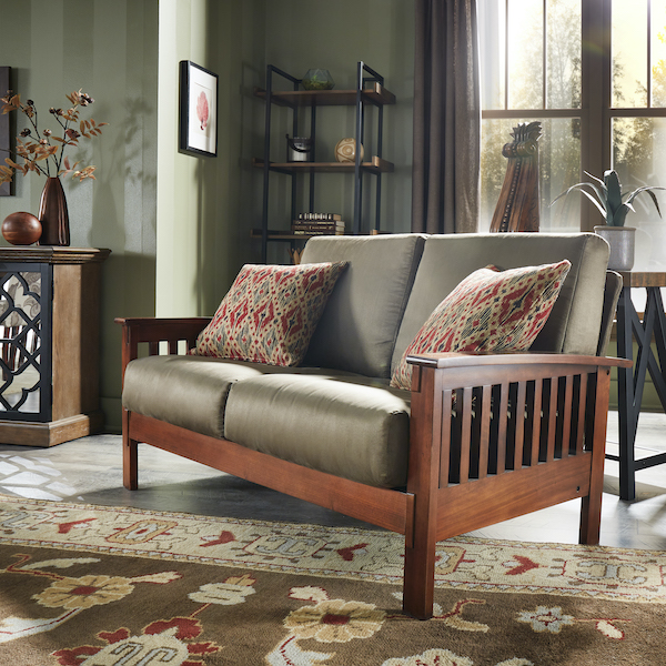 To return to cozy and familiar in our fall home décor trends, we display our Mission-Style Oak Wood Olive Microfiber Sofa. The sofa also features yellow, red, and green-printed accent pillows for added warmth and coziness.