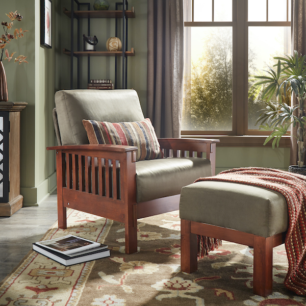  Pictured here is a closeup of the Mission-Style Olive Microfiber Upholstered Accent Chair and Ottoman. The chair features a striped lumbar pillow. A matching blanket is draped over the ottoman.